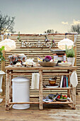 Rustic outdoor kitchenette with decoration on wooden terrace