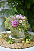 Late summer bouquet with dahlias, wild clematis seed heads, love-in-a-mist seed heads, roses and sedum