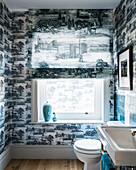 Bathroom with toile de jouy wallpaper and blue wall tiles