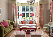 Classic living room with bay window, patterned curtains and living room furniture
