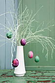Sprayed twigs with dyed Easter eggs