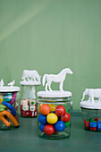 Preserving jars with plastic figurines with marbles, modeling clay and dice