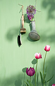 Decoration with flowers hanging on bright green wall