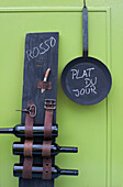 Frying pan and DIY wine rack made of wooden plank and old belts