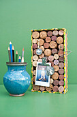 Vase with pencils and DIY bulletin board made of various corks
