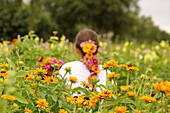 Woman with flowers in her hair in field of flowers