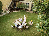 Family eating together in the garden in summer