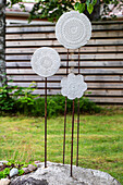 Garden decorations made from ornate concrete discs