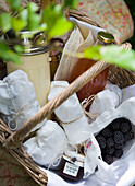 Picnic basket with packed delicacies and blackberries