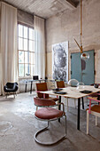 Loft study with concrete walls, modern art and retro furniture