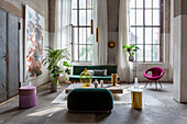 Loft living room with retro sofa, plants and large windows