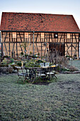 Garden table in front of barn on frosty day