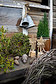 Wooden stars, bells, Thuja wreath and mistletoe on garden table