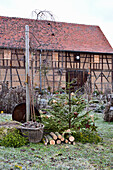 Christmas tree with wooden decorations in front of barn