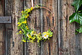 Floral wreath on rustic wooden wall