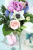Spring bouquet of tulips, roses, grape hyacinths and anemones