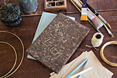 DIY project book on a wooden table with craft materials