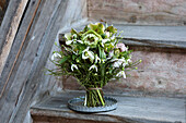 Bouquet of early flowers (black hellebore, Lenten rose, bilberry twigs and snowdrops)