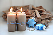 Beige advent candles with blue glass stars and driftwood wreath