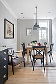 Dining area in open-plan kitchen with light grey walls
