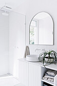 Arched mirror in the bathroom all in white
