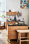Kitchen island and handmade wooden trestle bench in open-plan kitchen