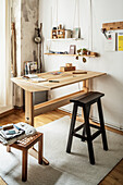 Handmade wooden desk and tall trestle stool