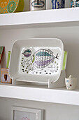 Serving dish with fish painting on shelving
