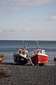 Fishing boats beached on Devon shingle