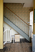 Patterned wallpaper and painted staircase of Rye interior, Sussex