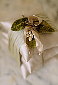 Detail of cushions wrapped with a ribbon and an elaborate bow on top
