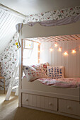 Bunk beds in floral patterned attic space in Rye, Sussex