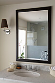 Black mirror frame above wash basin in Rye bathroom, Sussex