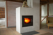 Lit fire in stove in country style room