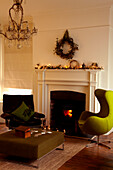 Retro armchairs at hearthside with Christmas fairylights