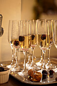 Champagne glasses with raspberry kir