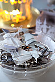 Paper decorations and scissors in a glass bowl