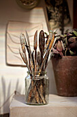 Rusty palette knives in glass jam jar artisan's home Brighton, Sussex, UK