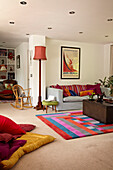 Colourful seating area in living room of houseboat in Richmond upon Thames, England, UK