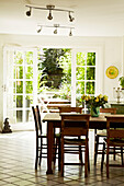 Wooden dining table and chairs in dining room of Brighton townhouse, Sussex, England, UK