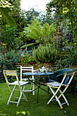 Folding table ad chairs in back garden of Brighton townhouse, Sussex, England, UK