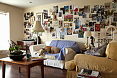 Dog sleeping on sofa in living room with artwork montage in Lincolnshire home, England, UK
