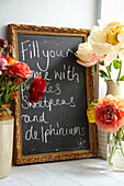 Handwriting on blackboard with cut flowers in Lincolnshire home, England, UK