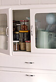 Close up detail of a small storage cabinet with ridged glass windows