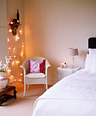 Double bed in bedroom decorated with fairy lights