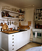 Kitchen with white cupboard unit and shelves Stockholm Sweden