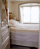 White and cream bedroom with lace pillows and bedcover