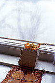 Dried flower and brick hand-made coaster on window sill