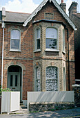 An exterior of a brick built semi detached house sash windows front door