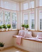 Detail of a window seat windows plants in pots on window sills